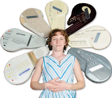 Jenny surrounded by a fan of Suzuki Omnichord models